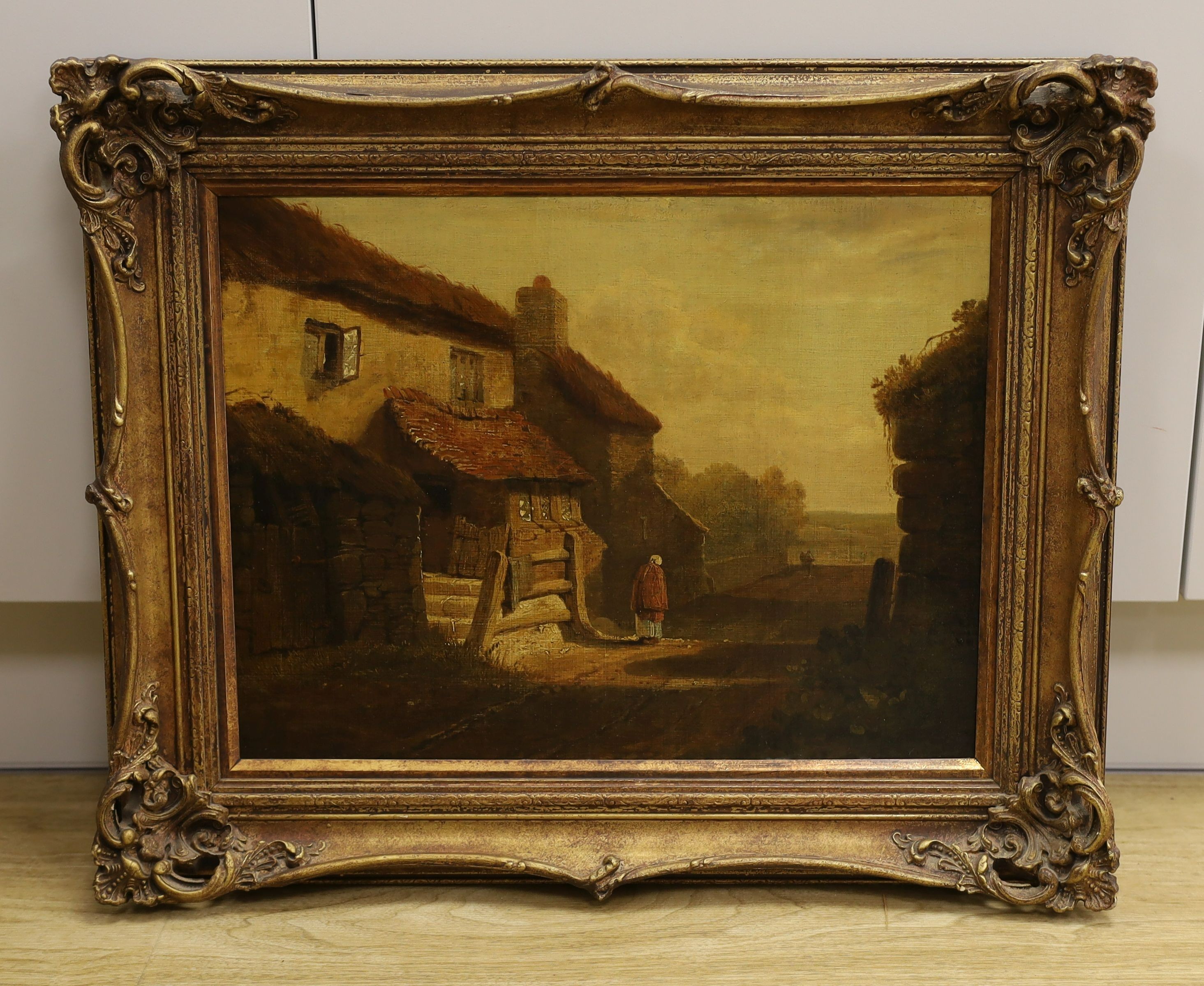 18th century English school, oil on canvas, woman on a lane passing cottages, 32 x 43 cm.